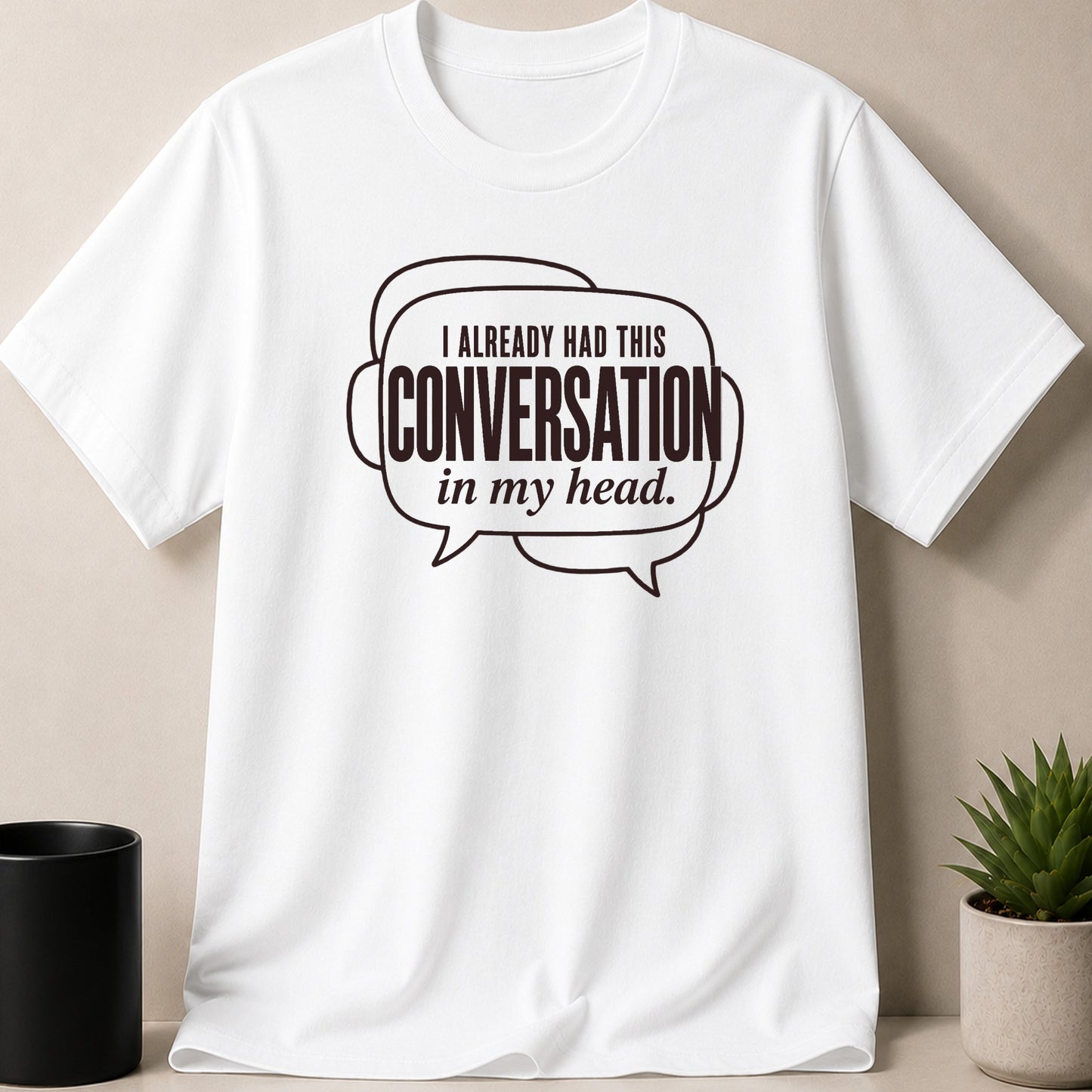 White t-shirt with speech bubble graphic reading "I already had this conversation in my head."